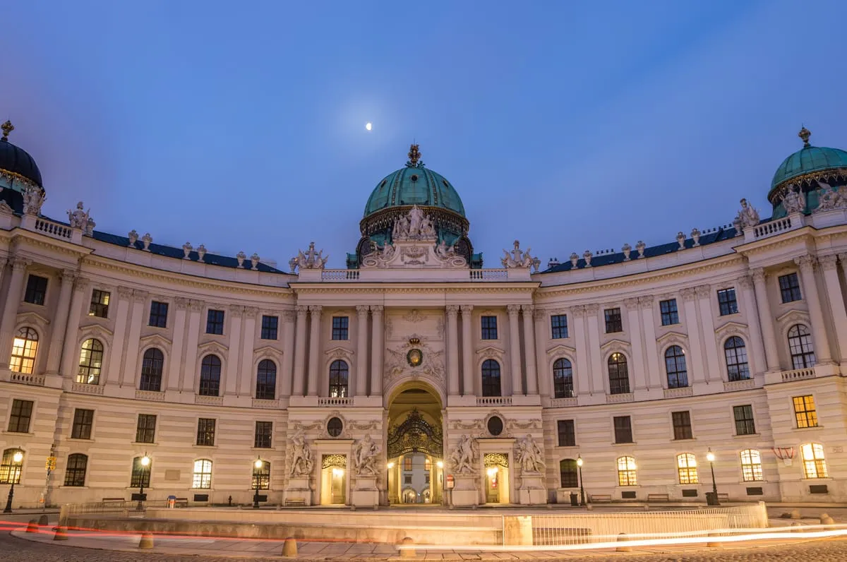 The domed St. Michael's Wing of the Hofburg on Michaelerplatz in Vienna at dusk